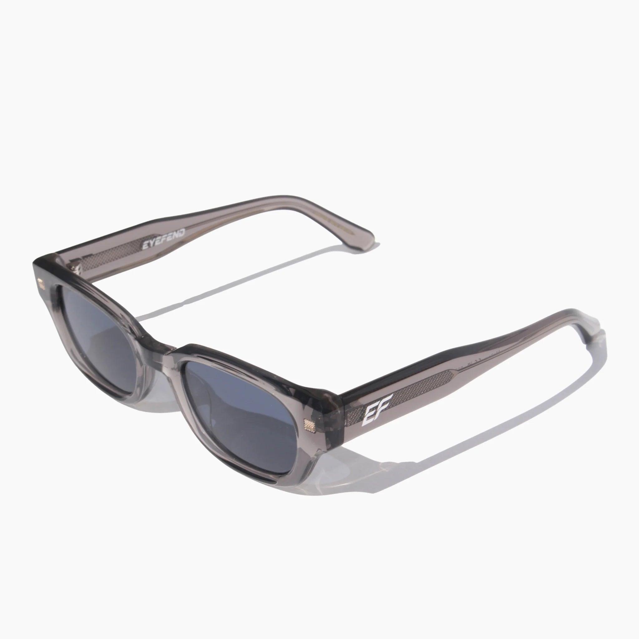 EyeFend Saphir clear grey acetate sunglasses featuring dark blue polarized lenses.