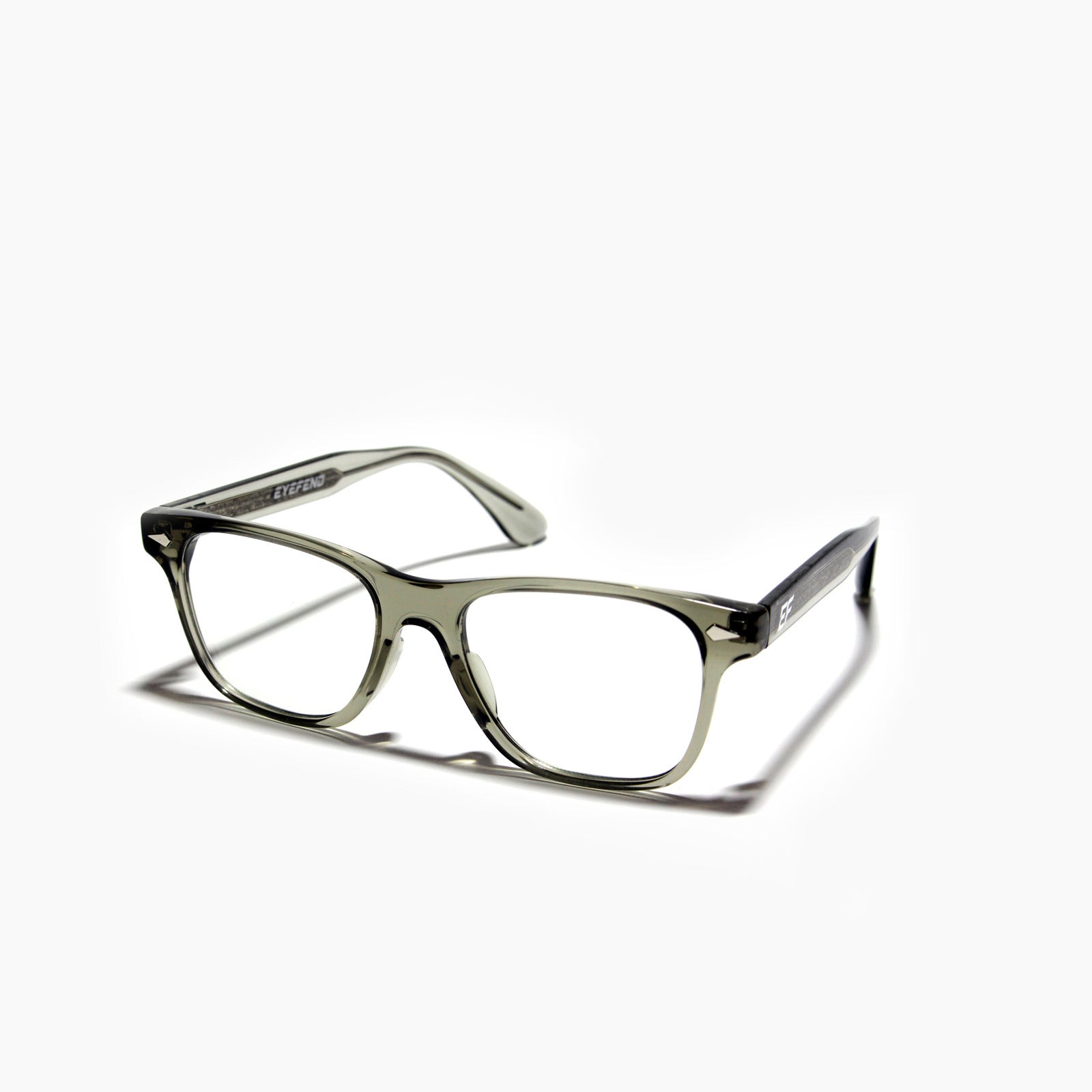 EyeFend premium photochromic blue light glasses in a rectangular translucent frame, featuring a minimalist structural design and durable multi-barrel rivet hinges.