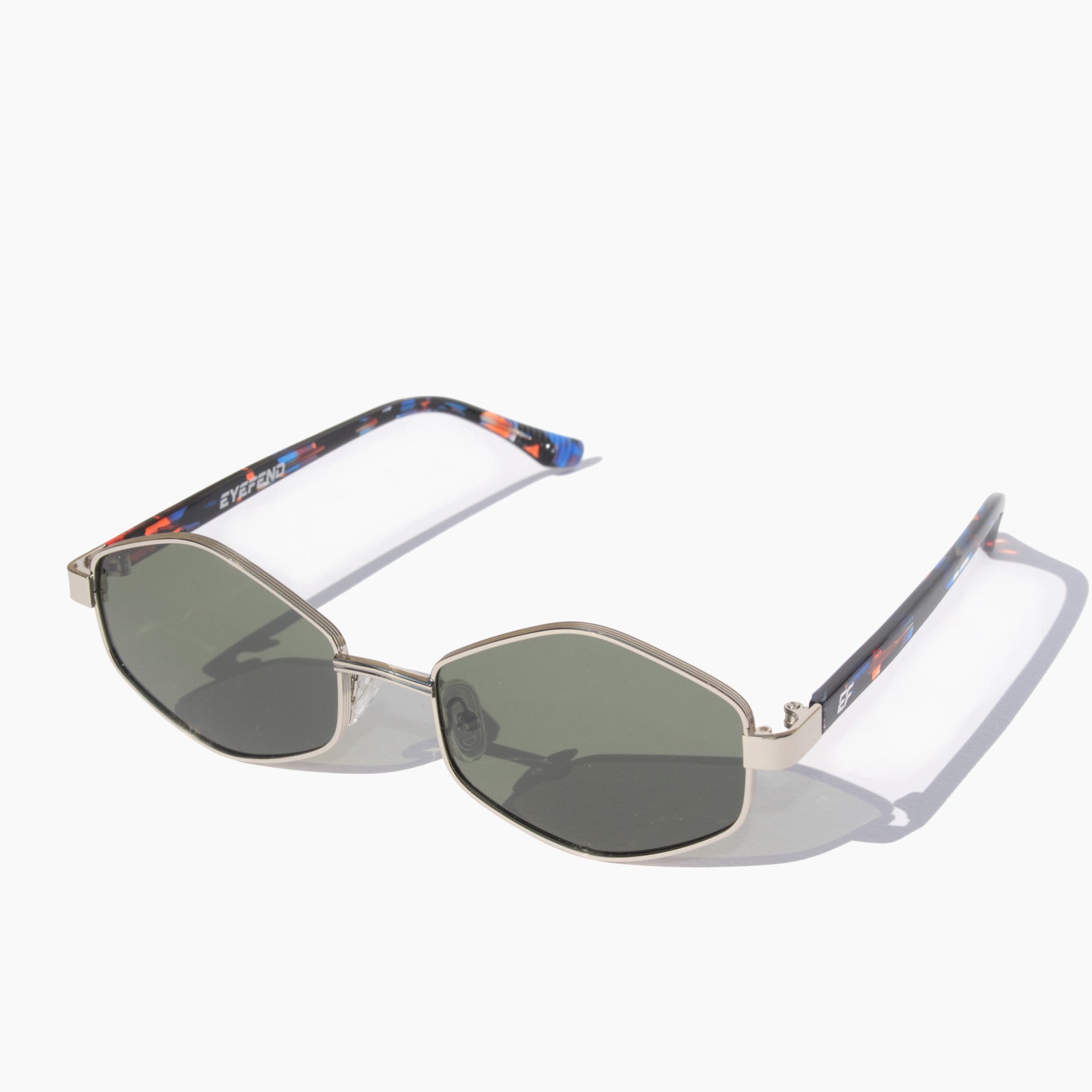 EyeFend Smart sunglasses featuring silver geometric hexagonal frames with green polarized lenses and tortoiseshell acetate temples.