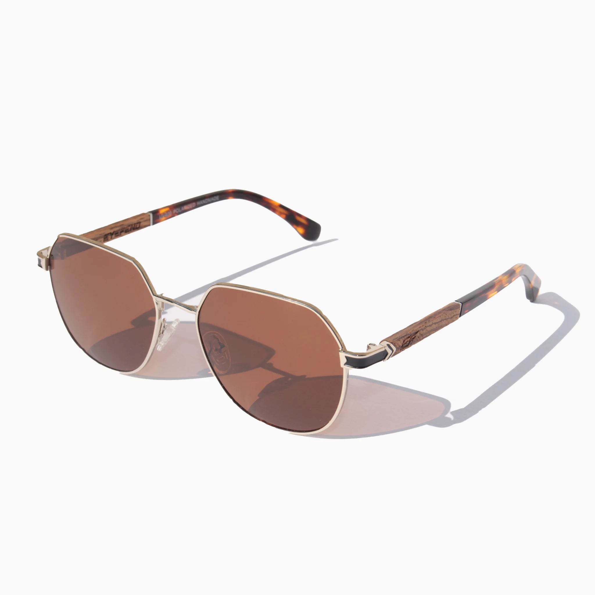 EyeFend Spark geometric aviator sunglasses featuring gold metal frames, brown polarized lenses, and textured wood-grain with acetate temple details